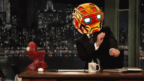 a man in a suit has a robot head on his head while sitting at a desk