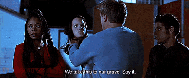 a group of people are standing around a man who says we take this to our grave