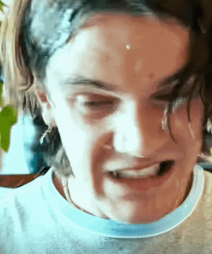 a close up of a person making a funny face with their mouth open