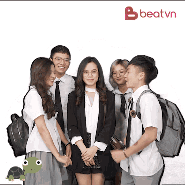 a group of people standing next to each other with a beat.vn logo in the background