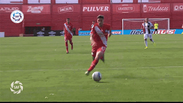 a soccer game is being played in front of a banner that says ' pulver ' on it