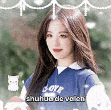 a girl in a blue shirt is holding a football and a cat .