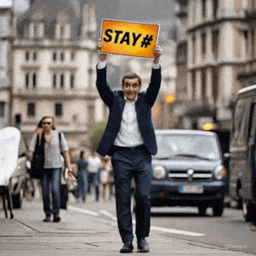 a man in a suit holds a sign that says stay #