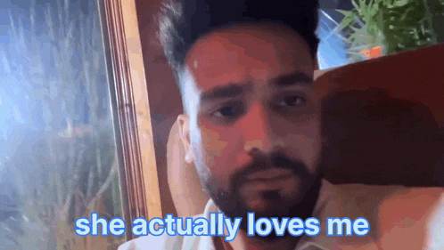 a man with the words she actually loves me written on his face