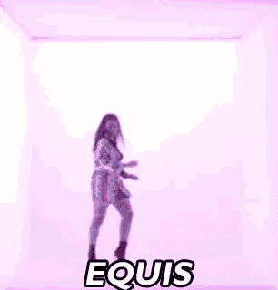 a woman is dancing in a pink room with the word equis written on the wall .
