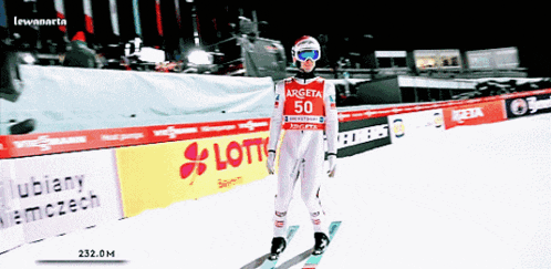 a skier wearing a red and white argeta 50 jersey