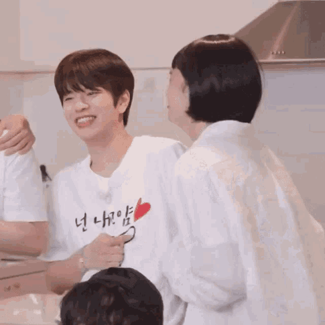 a boy wearing a white shirt with a heart on it