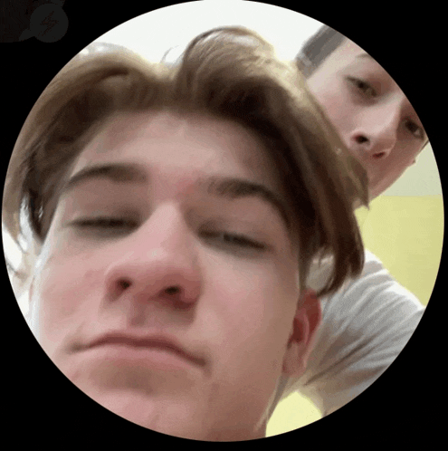 a close up of a person 's face in a circle with a yellow background