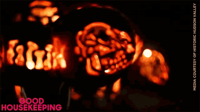 a picture of a carved pumpkin with the words good housekeeping underneath it