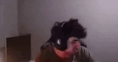 a man wearing headphones is sitting in a chair .