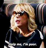 a woman wearing sunglasses is sitting on a couch and saying help me i 'm poor