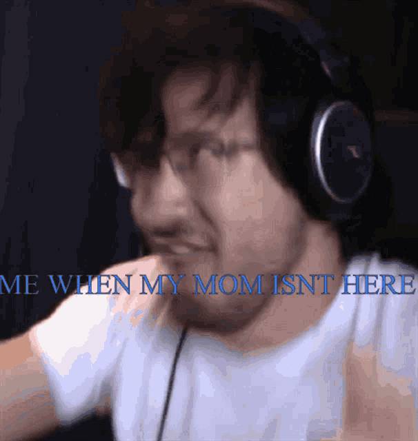 a man wearing headphones with the words me when my mom isn t here