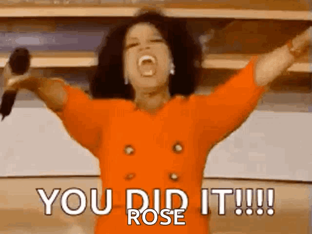 oprah winfrey is holding a microphone in her hands and screaming .