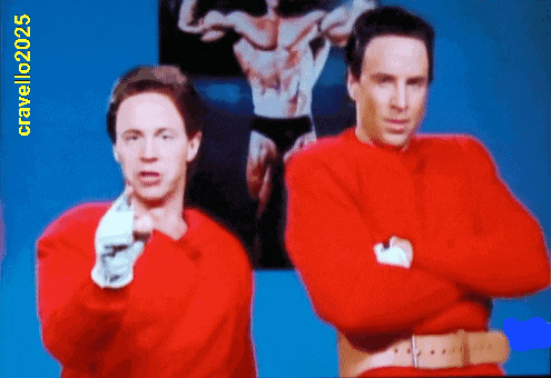 two men in red sweaters are standing next to each other with a picture of a man in black underwear behind them and the year 2025