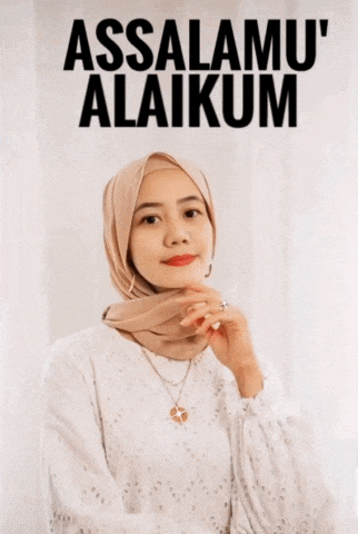 a woman wearing a hijab is standing in front of a sign that says assalamu ' alaikum