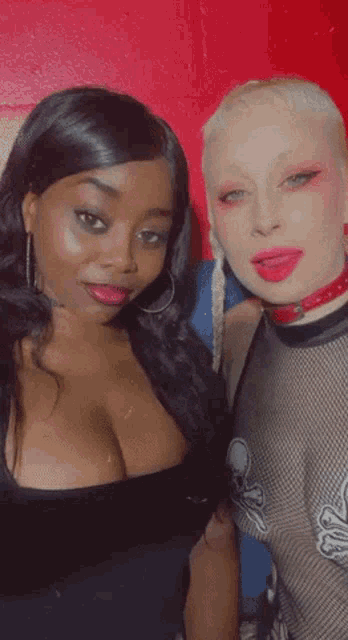 two women are posing for a picture and one is wearing a choker