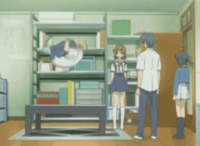 a man and two girls are standing in a room with a table