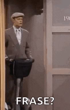 a man in a suit and hat is standing in front of a door holding a suitcase and a bag and says frase ?