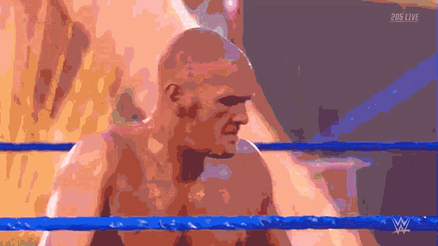 a man in a wrestling ring with a 205 live logo on the bottom