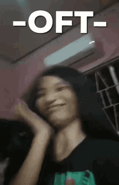 a blurry picture of a girl with the words -oft- behind her