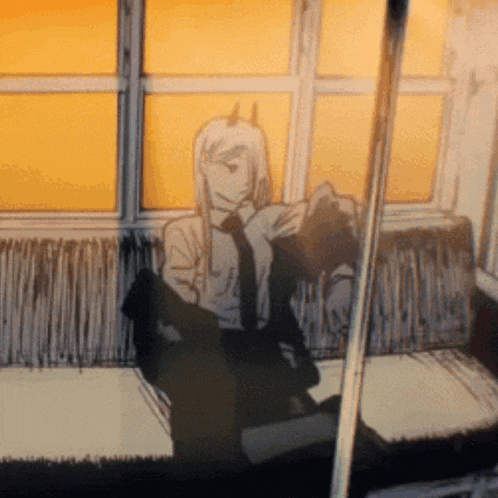 a man in a suit and tie is sitting on a train looking out a window