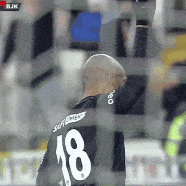 a soccer player with the number 18 on his shirt