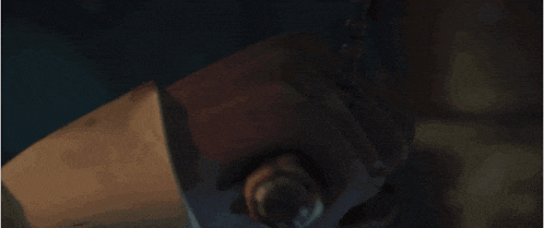 a close up of a person holding a bottle with a chain around it .