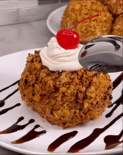 a close up of a dessert with a cherry on top