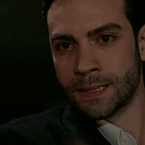 a man with a beard wearing a suit and white shirt