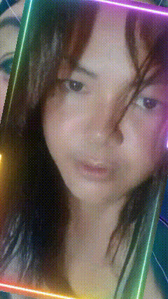 a close up of a woman 's face with a rainbow colored frame around her