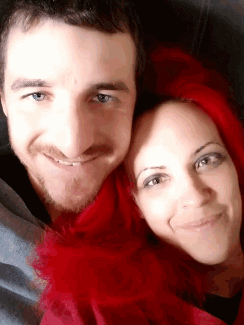 a man and a woman are posing for a picture