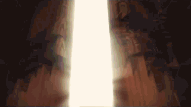 a white light is shining through a dark tunnel