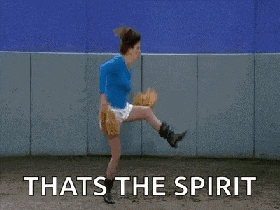 a woman is throwing a baseball and the words `` that 's the spirit '' are written above her .