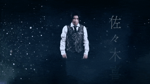 a man in a suit and tie is standing in front of chinese characters
