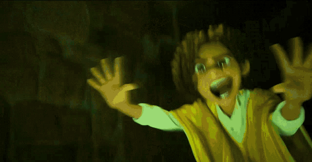 a person in a yellow shirt is screaming with their hands in the air