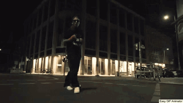 an easy gif animator shows a person dancing on a street at night