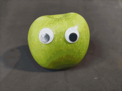 a close up of a yellow object with big eyes on it