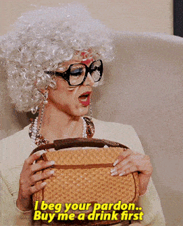 a woman in a wig and glasses is holding a purse and says i beg your pardon buy me a drink