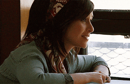 a woman wearing a scarf that says gucci on it