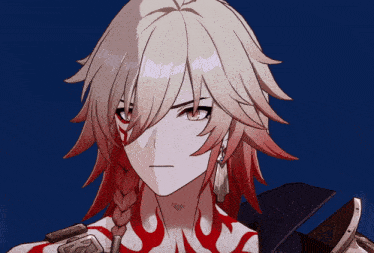 a close up of a person 's face with a red flame on their chest