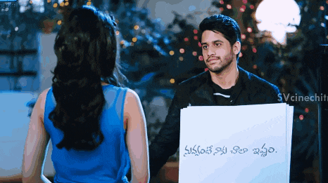 a man is holding a piece of paper that says ' svcinechit ' on it