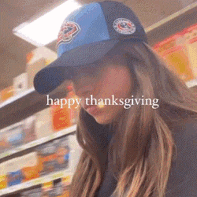 a woman wearing a baseball cap with the words happy thanksgiving on the bottom