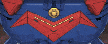 a close up of a blue and red robot with a yellow light on it