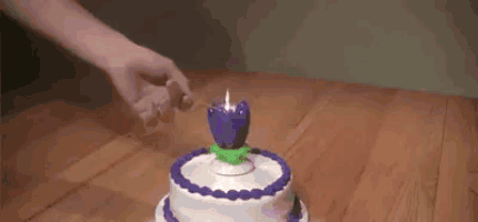 a person is blowing out a birthday candle on a cake .