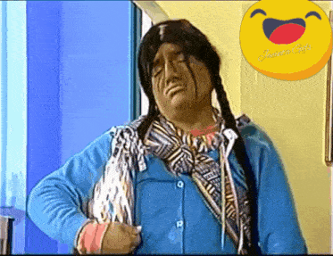 a man in a native american costume has a laughing smiley face behind him