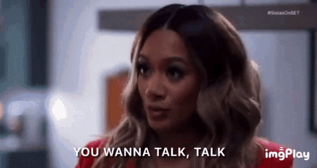 a woman says " you wanna talk talk " while looking at the camera
