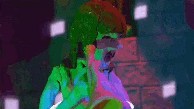 a close up of a yellow sculpture with a green light behind it