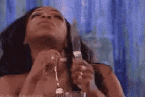 a woman is holding a knife in her mouth .