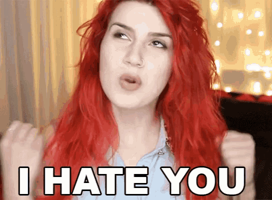 a woman with red hair is making a face and saying i hate you