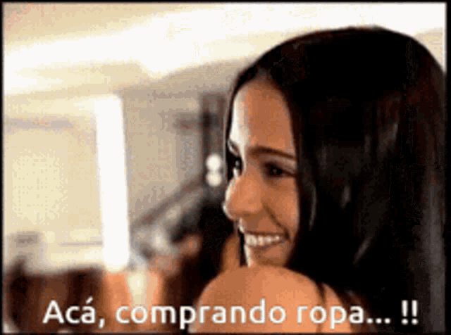 a woman is smiling with the words aca comprando ropa written above her